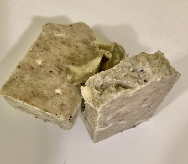 Two bars of natural soap on an off-white background. The herb coloring comes from the gotu-kola ingredient. It has a neutral scent.